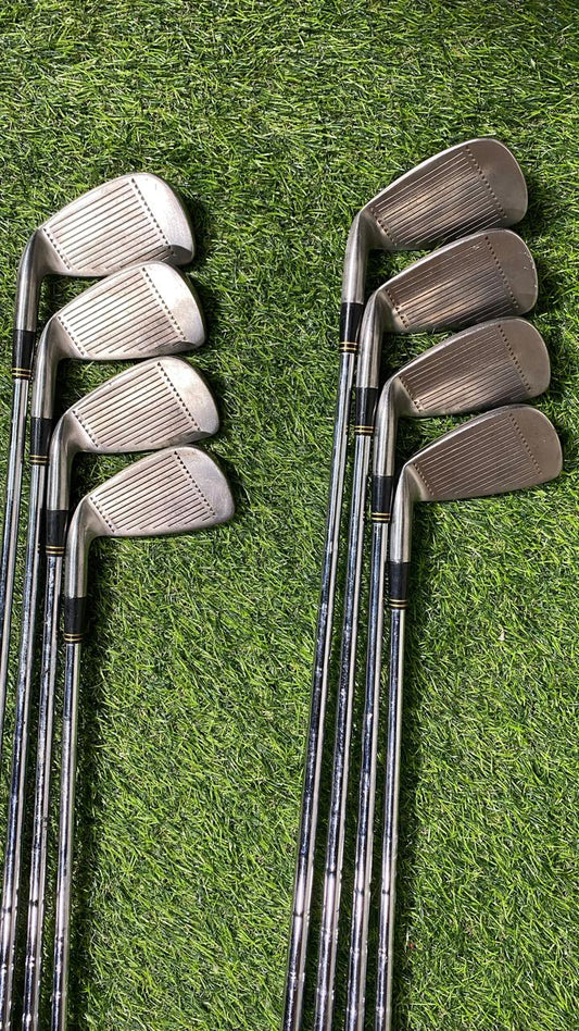Set of golf clubs on a grassy background