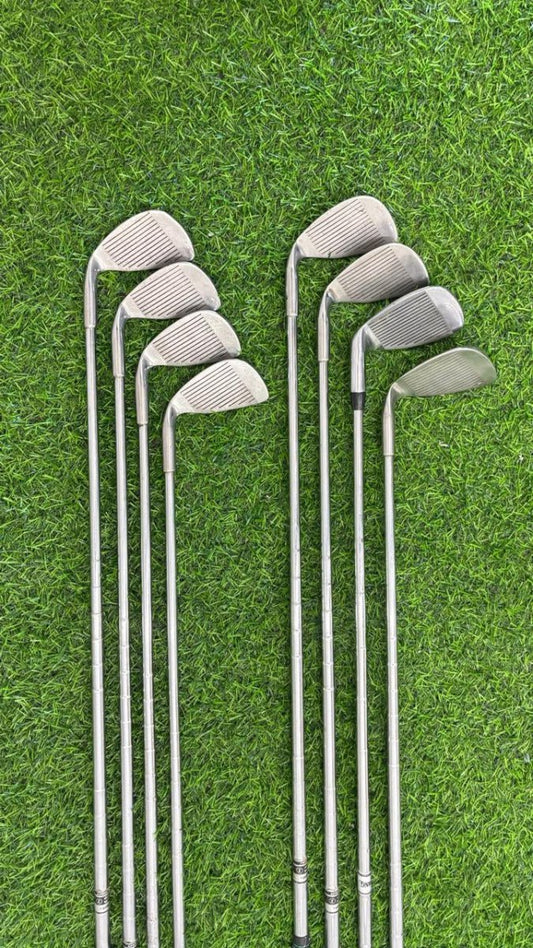 Set of golf clubs on a grassy background