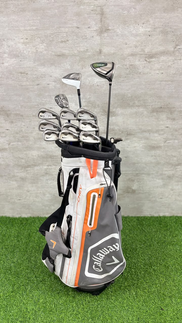 Callaway golf bag with clubs on a grass and concrete background