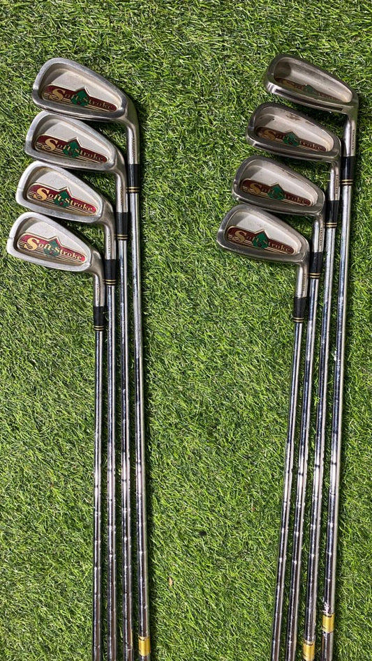 Set of golf clubs on a grassy background