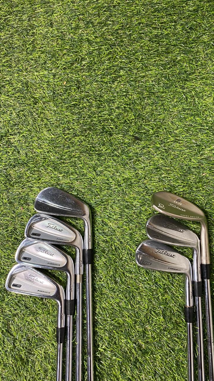 Set of golf clubs on a grassy background