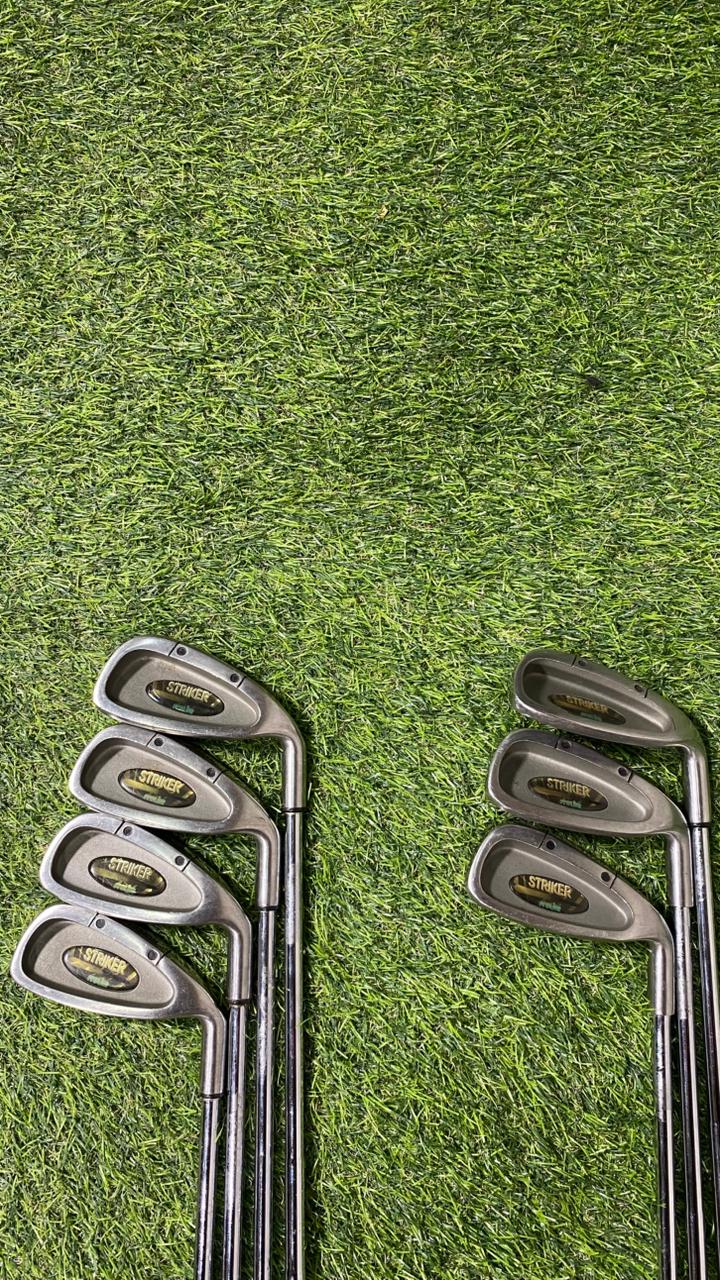 Set of golf clubs on a grassy background