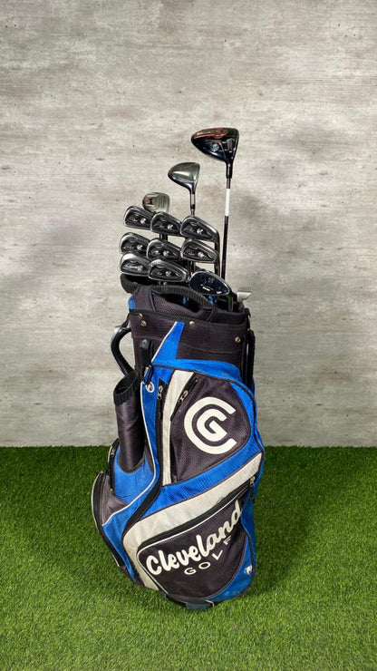Golf clubs in a Cleveland golf bag on a grass and concrete background
