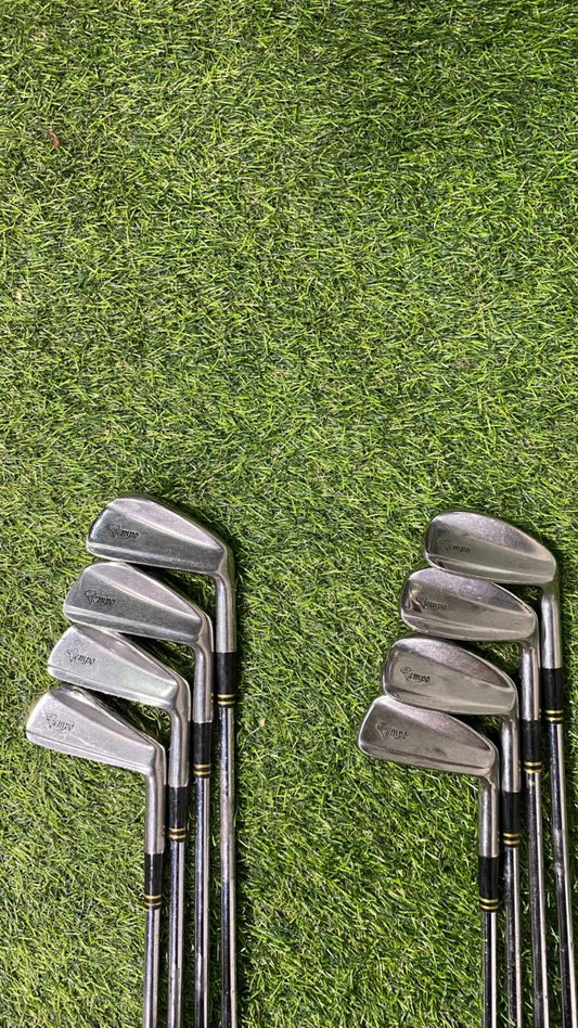 Set of golf clubs on a grassy background