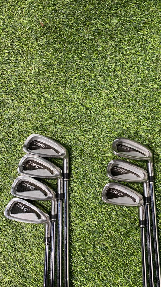 Set of golf clubs on a grassy background