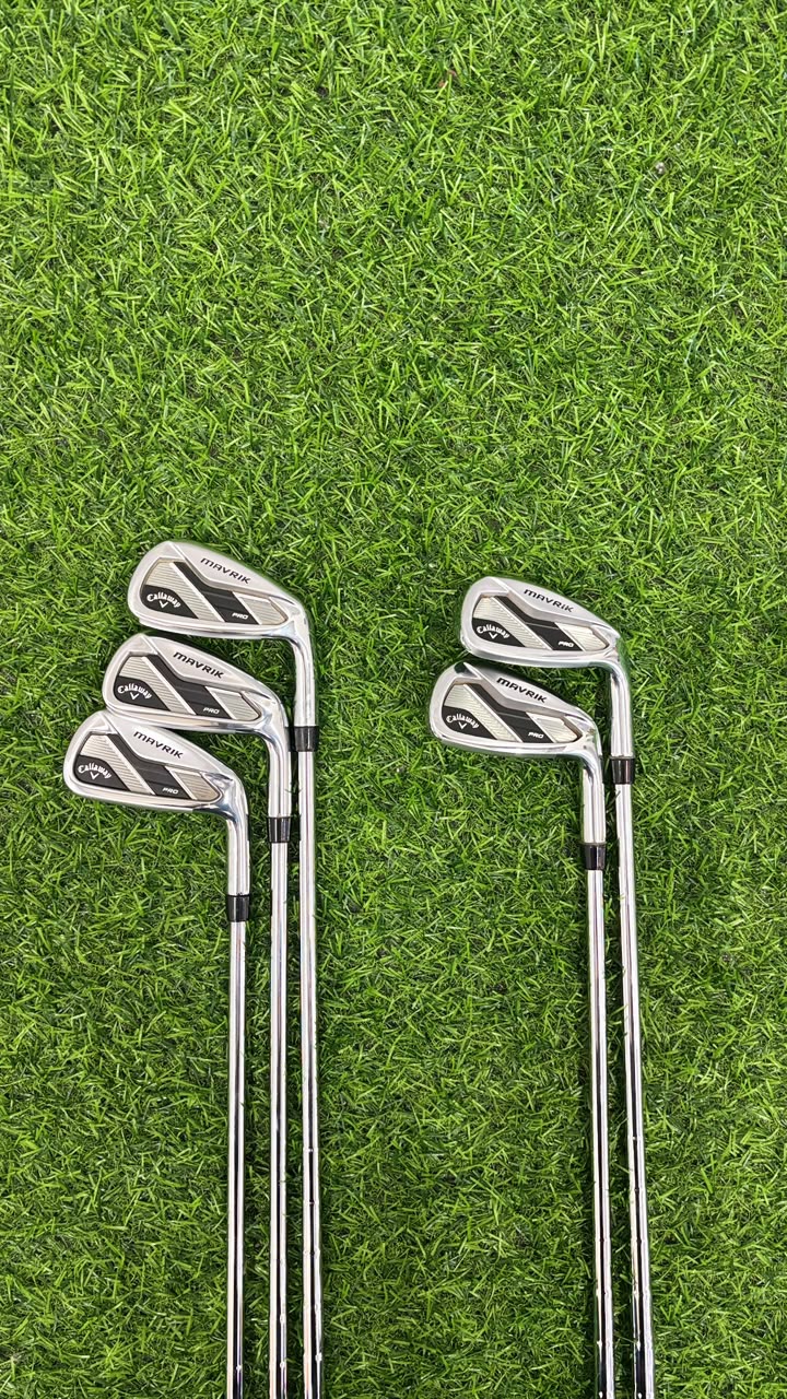 Set of golf clubs on a grassy background