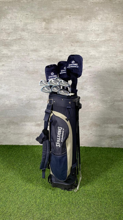 Golf bag with clubs against a textured wall and green floor