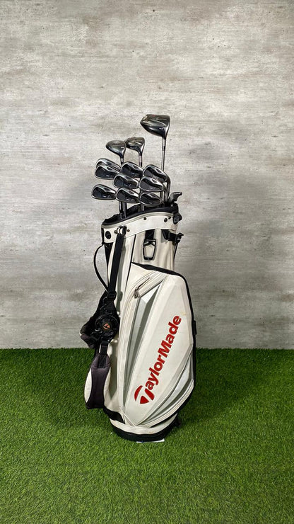 Golf club set with TaylorMade bag on a green surface and gray background