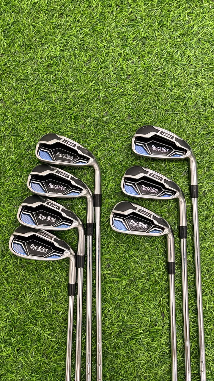 Set of golf clubs on a grassy background