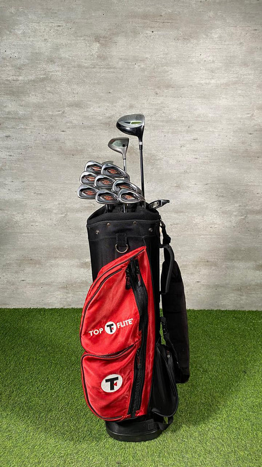 Red golf bag with clubs on a green surface and gray wall background