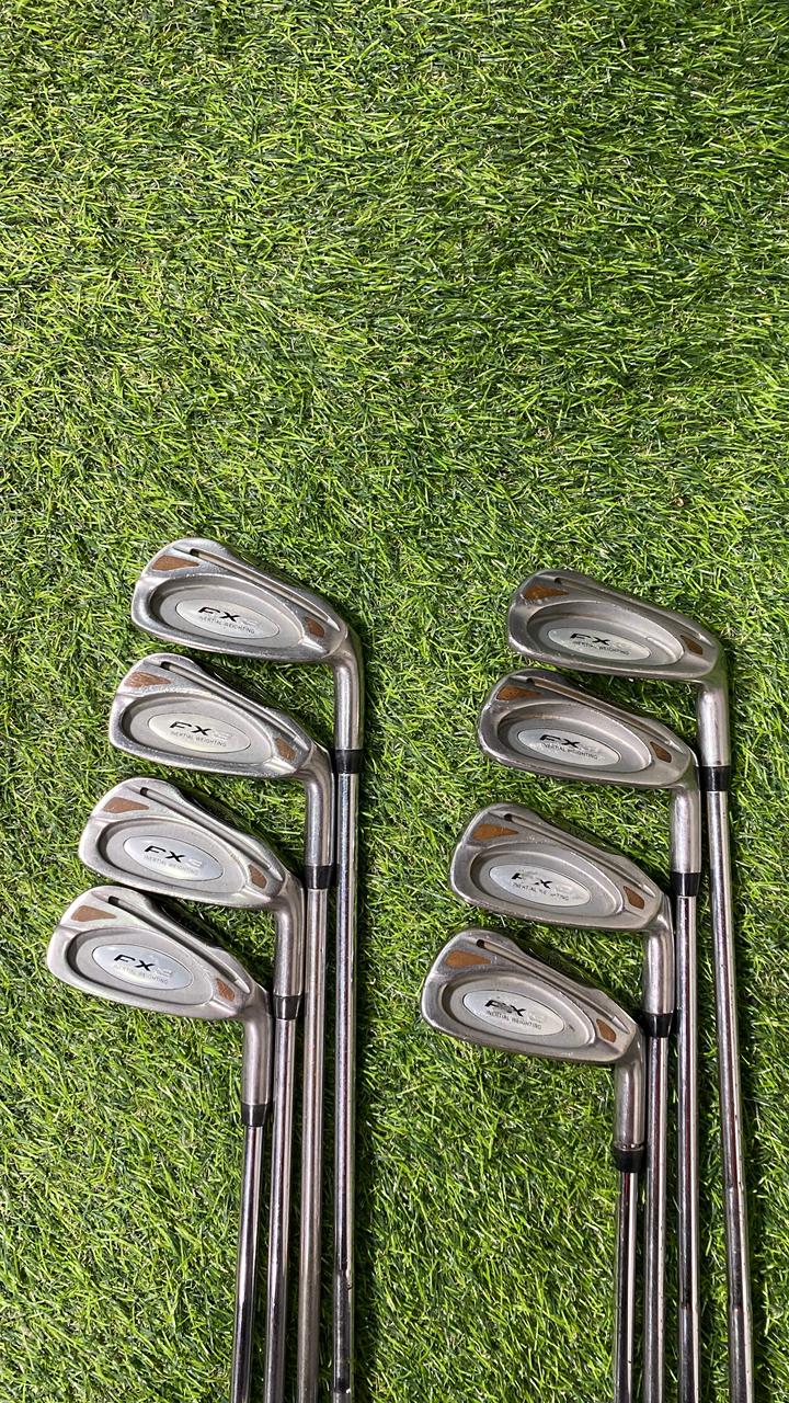 Set of golf clubs on a grassy background