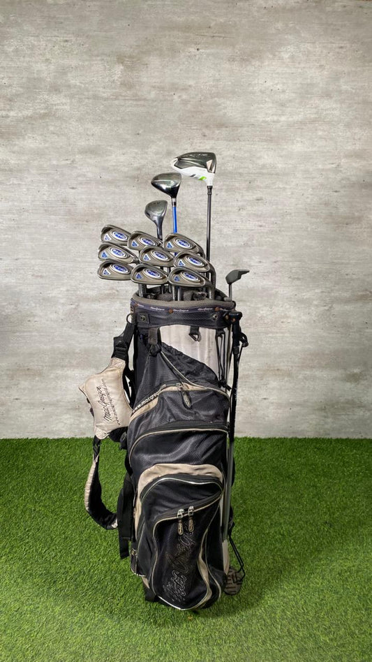 Golf clubs in a bag on a green and gray background
