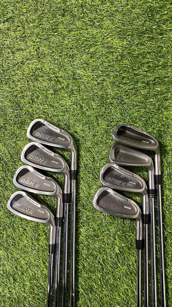 Set of golf clubs on a grassy background