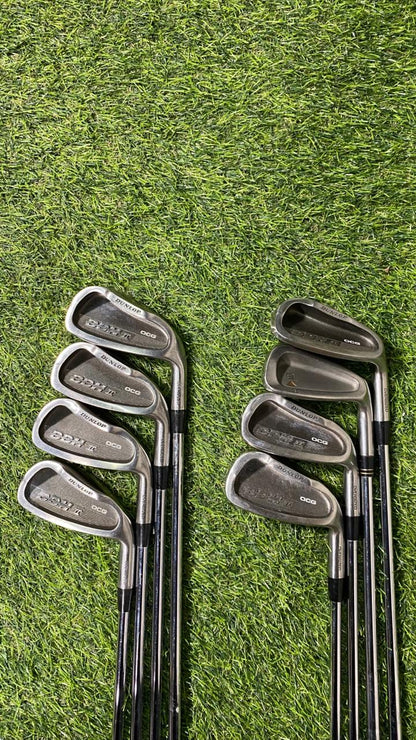 Set of golf clubs on a grassy background