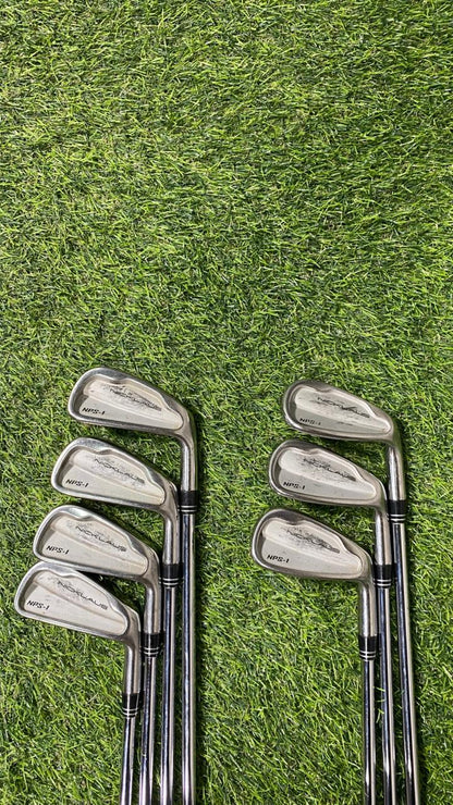 Set of golf clubs on a grassy background
