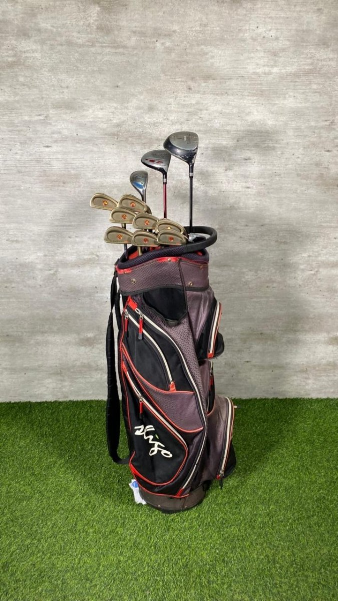 Golf clubs in a bag on a green surface with a gray wall background