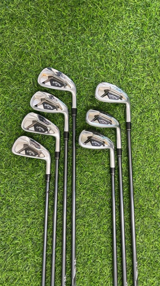Set of golf clubs on a grass background