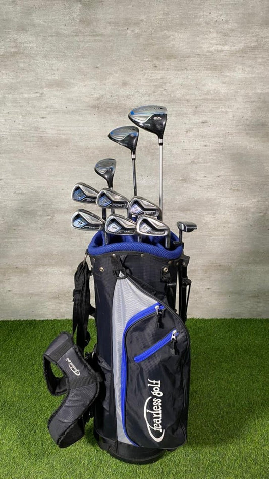 Golf club set with bag on grass and concrete background
