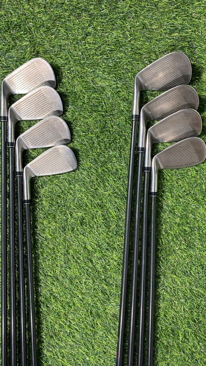 Set of golf clubs on a grassy background