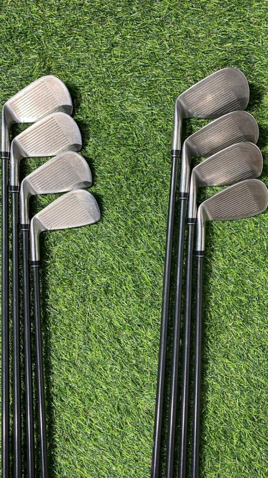 Set of golf clubs on a grassy background