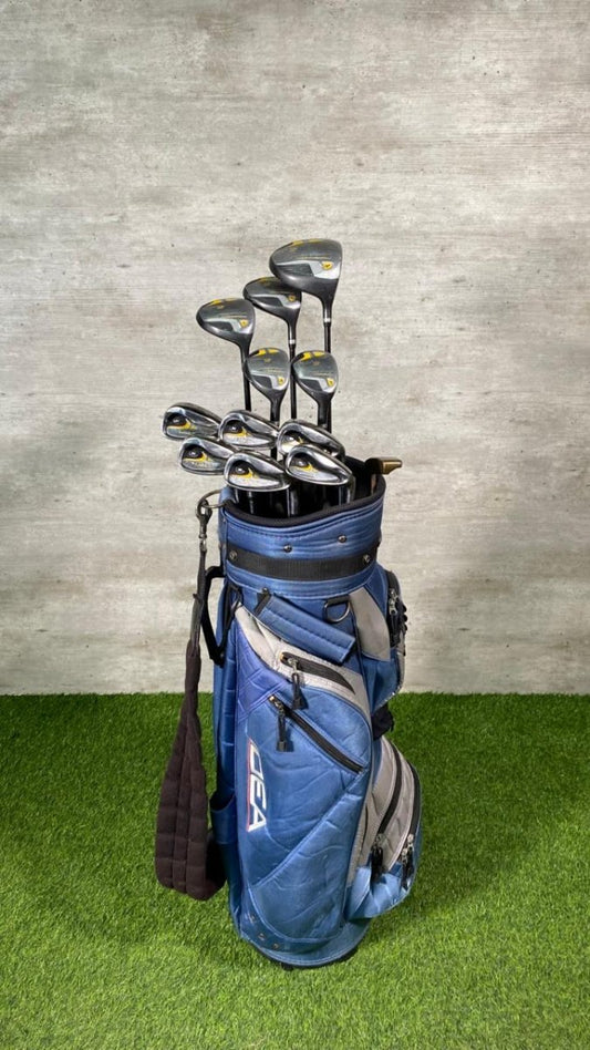 Blue golf bag with golf clubs on a green and gray background