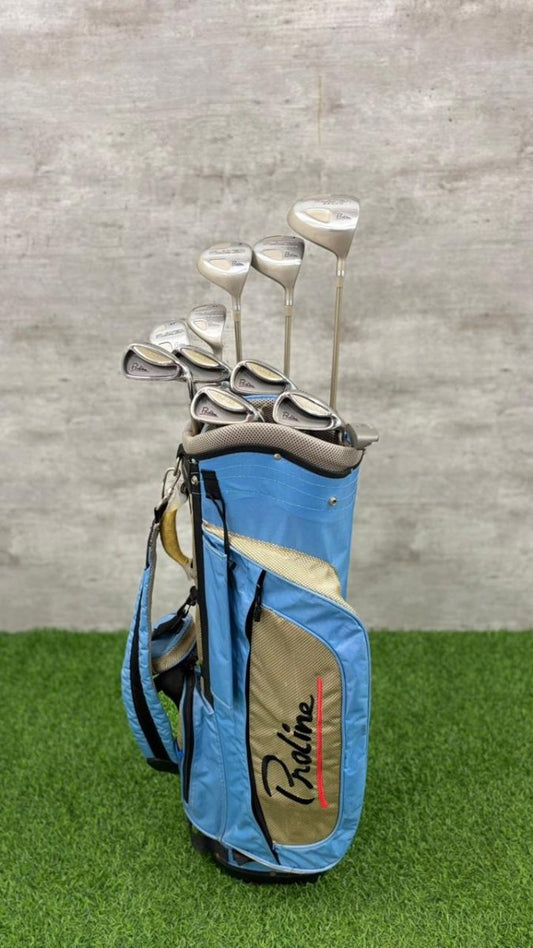 Blue golf bag with golf clubs on a grassy surface