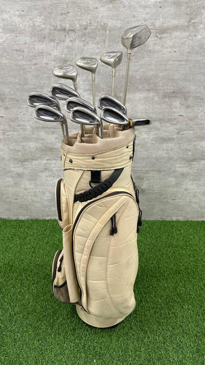 Beige golf bag with golf clubs on a green and gray background
