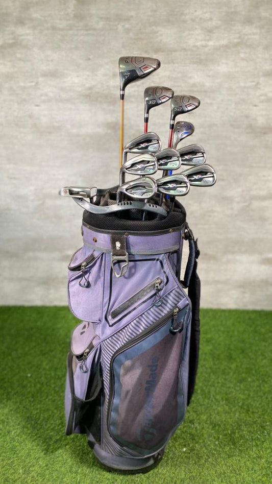 Golf clubs in a gray bag on a green and gray background