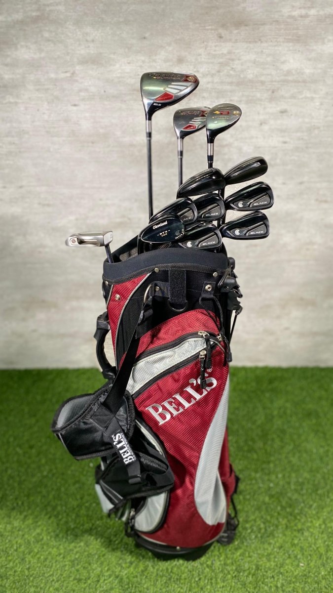 Golf club set with red and black Belco bag on a green surface and gray background