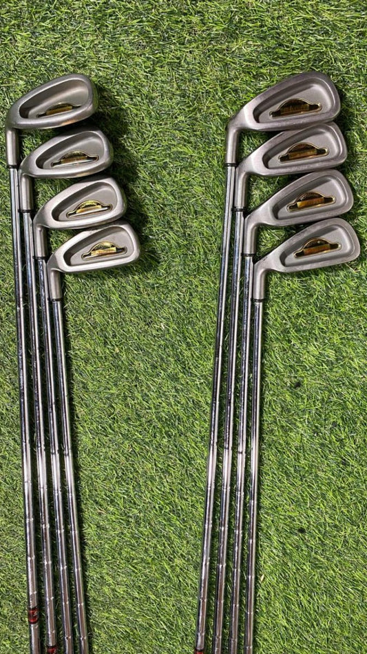 Set of golf clubs on a grassy background