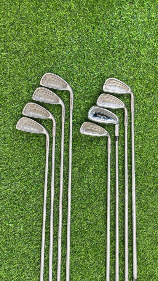 Set of golf clubs on a grass background