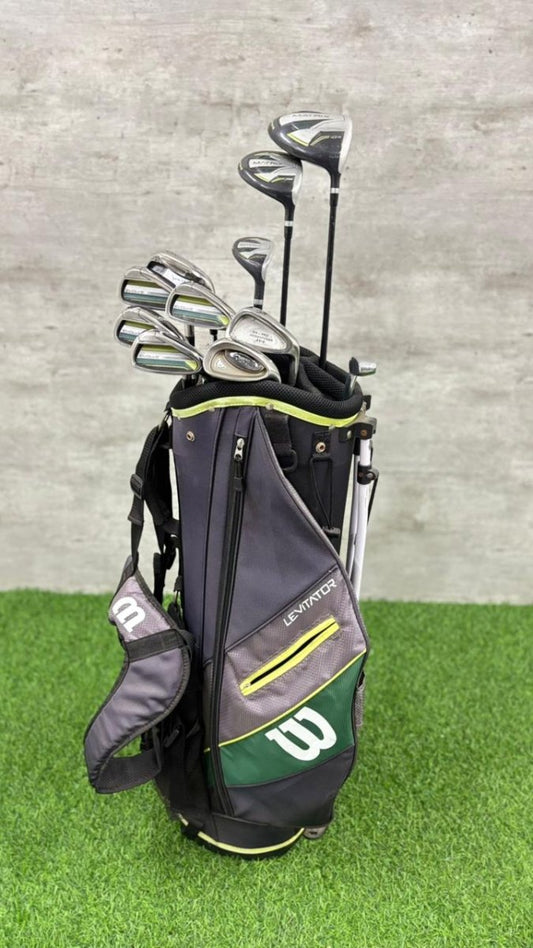 Golf bag with golf clubs on a grassy surface