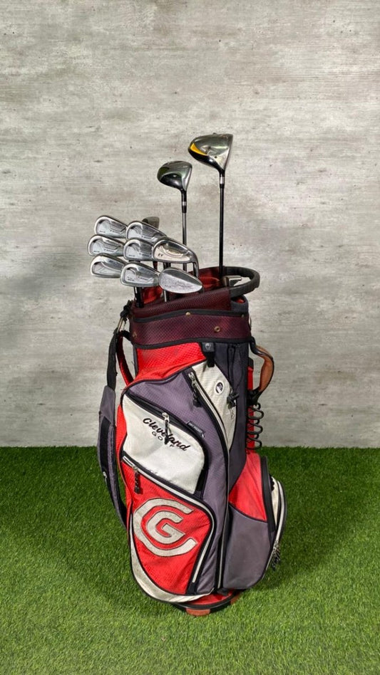 Golf bag with clubs on a grass and concrete background
