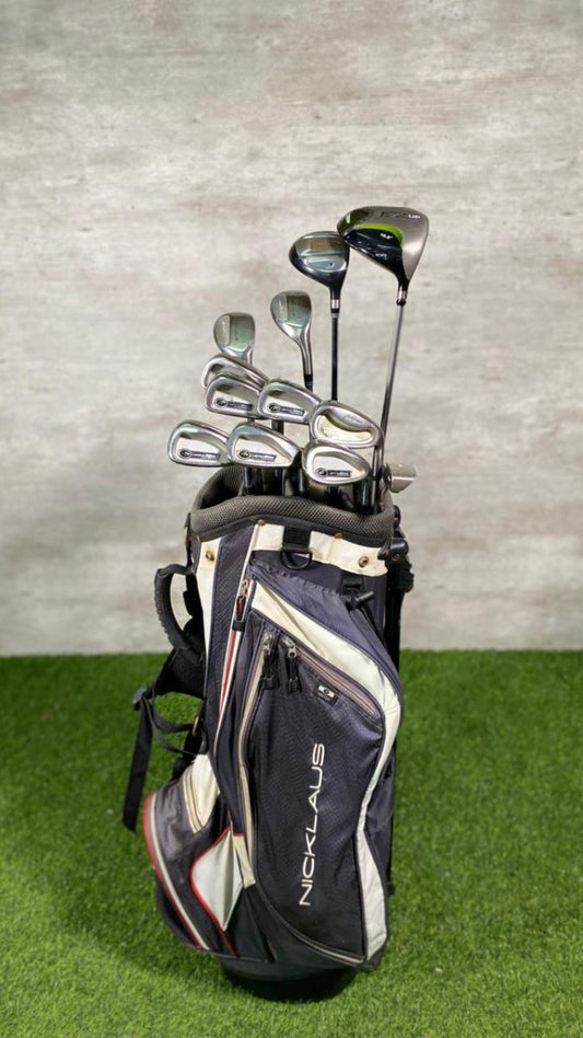 Golf club set in a bag on a green surface with a gray background