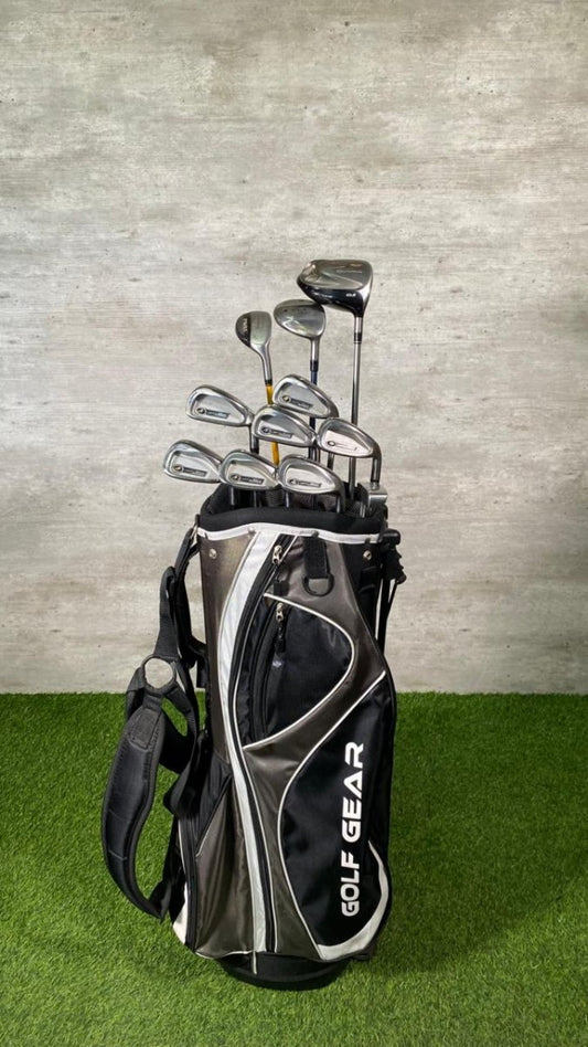 Golf club set in a black bag with 'GOLF GEAR' branding on a grassy surface.