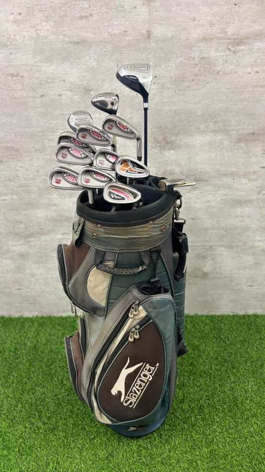 Golf club set in a bag on a grass and concrete background