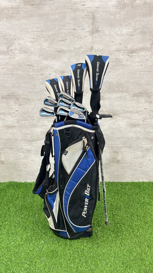 Golf club set in a black and blue bag on a green and gray background
