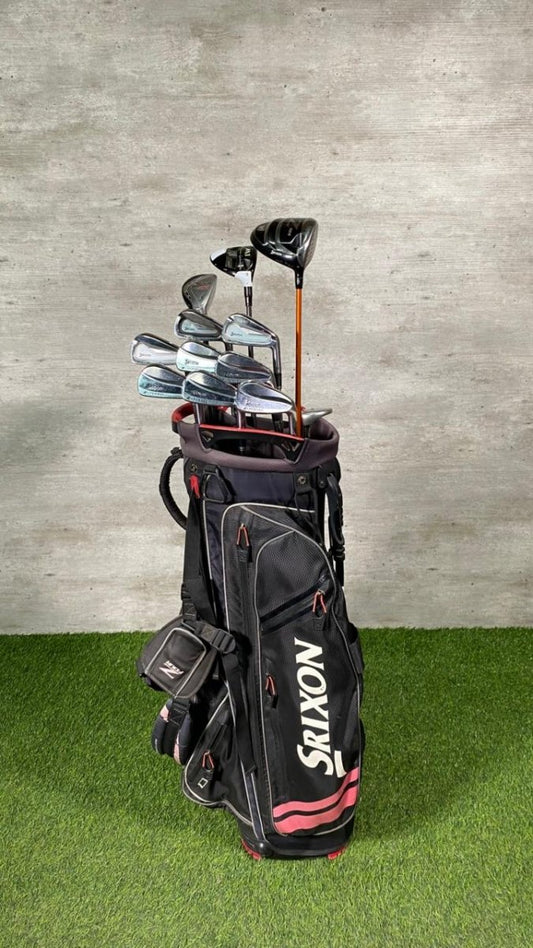 Golf clubs in a black bag with 'Srixon' branding on a grassy surface.