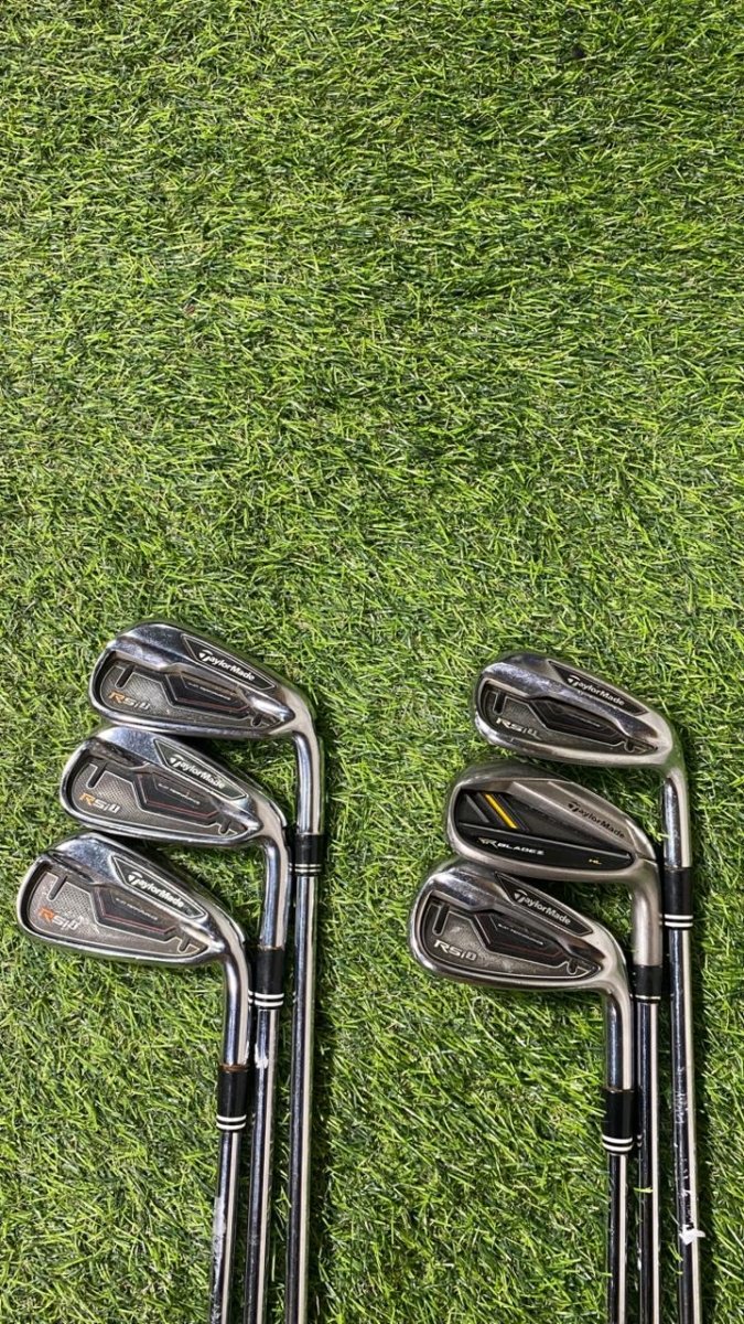 Set of golf clubs on a grassy background