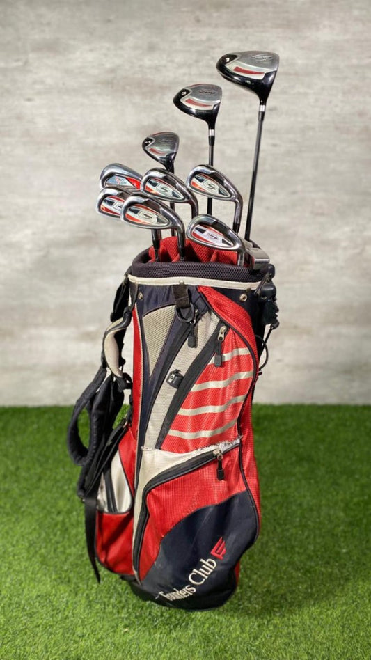 Red golf bag with golf clubs on a grassy surface