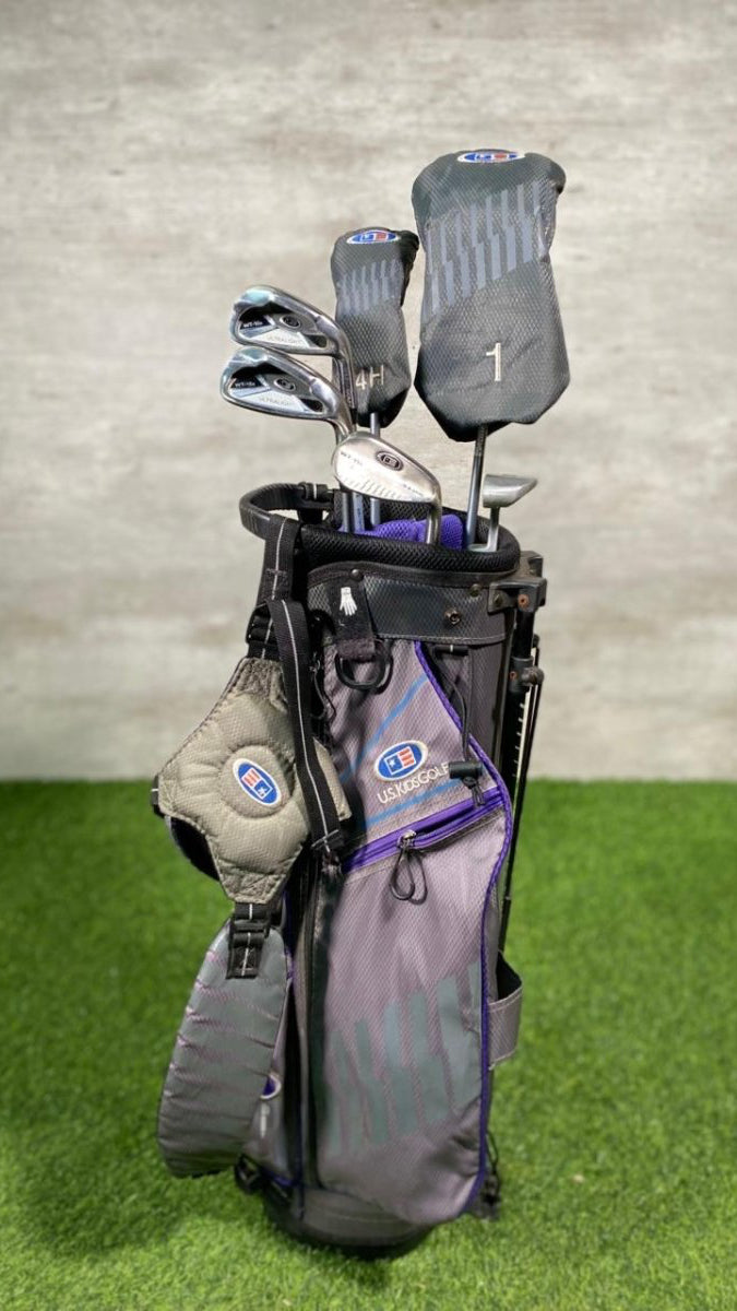 Golf bag with clubs on a grassy surface